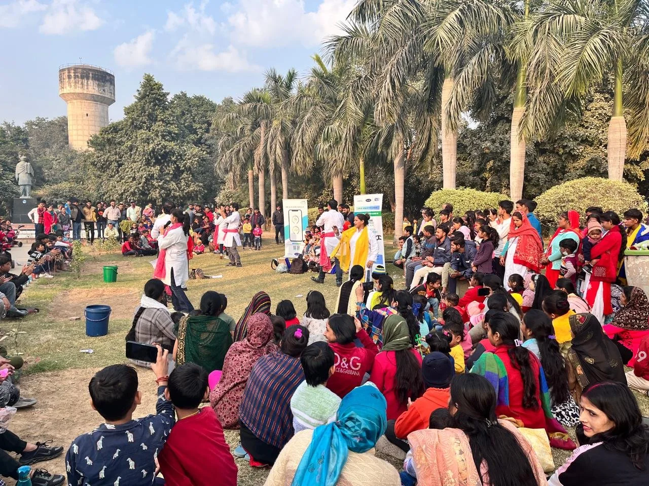 Community members gather outdoors for a Sambhawna awareness performance